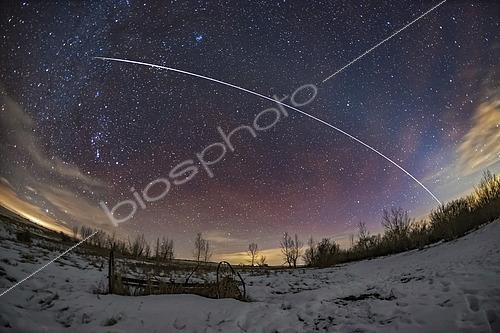 Biosphoto | 2481460 | A pass of the International Space Station on the evening of January 26, 2019. The ISS is moving from right to left, southwest to southeast. . . The ISS faded and reddened naturally into sunset at top left in Taurus. Just before it did that it passed through the Hyades star cluster and just missed Aldebaran. . . The ISS seemed to track along the ecliptic here, made somewhat visible by the faint arc of the zodiacal light reaching up from the horizon at right and stretching across the sky to the upper left. The ISS coincidentally travelled parallel to, but just below the zodiacal light, which follows the ecliptic. . . Some red streaks of airglow are also visible, and I emphasized those in the colour correction to make a more colourful sky. I did the opposite to the light polluted clouds! But their yellow remains.
 | &copy; Alan Dyer / Stocktrek Images / Biosphoto