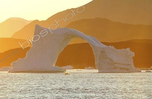 Biosphoto | 2057122 | Denmark. Greenland. West coast. Sunset on an arch shaped iceberg in the straight of Vaigat, near the village of Saqqaq. | &copy; Antoine Lorgnier / Biosphoto