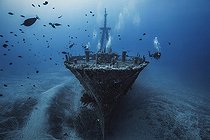 Biosphoto | 2091122 | Diver and the wreck of Hai Siang sliding by 55 m deep, Indian Ocean, Reunion | &copy; Gabriel Barathieu / Biosphoto