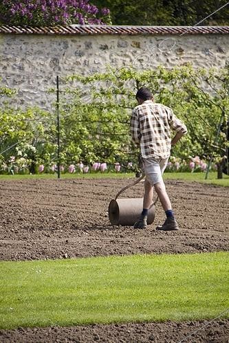 Biosphoto | 1275419 | Gardener pushing traditional roller, April | &copy; Lamontagne / Biosphoto