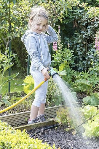 Biosphoto | 2101913 | Little girl watering the vegetable garden in summer, Pas-de-Calais, France | &copy; Yann Avril / Biosphoto