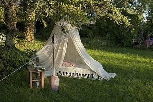 Biosphoto | 1403562 | Mosquito net over a bed in a garden | &copy; H. Curtis / Biosphoto