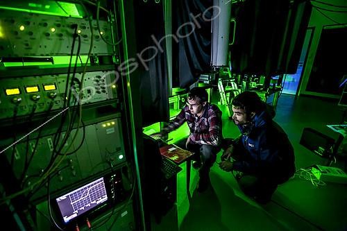 Biosphoto | 2072312 | Preparation of a Lidar laser at Maïdo,Observatoire de Physique de l'Atmosphère de la Réunion (OPAR). Reunion Island. Guillaume Payen, OPAR's technical manager, and Nicolas Marquestaut, research engineer, prepare the lasers for the night's shooting. These lidar lasers are designed to analyze certain components of the atmosphere. The Maïdo atmospheric observatory on La Réunion (one of the 3 measurement sites of the OPAR (Observatoire de Physique de l'Atmosphère de La Réunion), has been installed since October 2012 on the Piton Maïdo at an altitude of 2,200 meters. The laboratory is equipped with active and passive remote sensing instrumentation, enabling long-term, high-quality measurements of the vertical profiles of numerous climatic variables. It enables us to monitor atmospheric and climatic parameters in a context of accelerating climate change, and benefits from a unique situation in the tropical southern hemisphere, where observations are extremely rare. The observatory has 4 laser lidars, 2 of which are visible (green), and 2 invisible to the human eye. Three of the lidars are fired vertically, and one at 45 degrees, to measure wind. (i) One lidar is dedicated to measuring water vapour, with a large 1.20 m diameter telescope and two paired lasers. (ii) Three other LIDARS are designed to measure vertical profiles of atmospheric parameters (including one fired at 45 degrees, for wind measurements). The Maido observatory benefits from several major advantages. (1) Its latitudinal position for studying stratospheric transport processes. (2) Its altitude, free from pollution, humidity and light, considerably improves the quality of remote sensing measurements for studying the chemical composition of the atmosphere. OPAR's observations are part of several international observation networks, including NDACC (Network for the Detection of Atmospheric Composition Changes) and GAW (Global Atmospheric Watching). | &copy; Thibaut Vergoz / Biosphoto