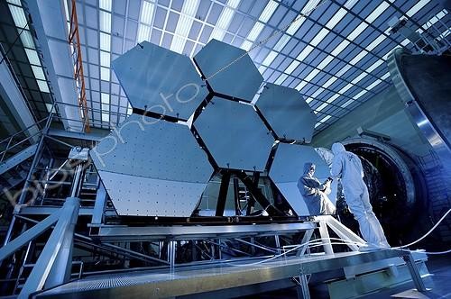 Biosphoto | 1632193 | Test of a telescope mirrors in deep cold USA ; Into the Looking Glass<br>Recently, technicians at NASA's Marshall Space Flight Center in Huntsville, Ala., completed a series of cryogenic tests on six James Webb Space Telescope beryllium mirror segments at the center's X-ray & Cryogenic Facility. During testing, the mirrors were subjected to extreme temperatures dipping to -415 degrees Fahrenheit, permitting engineers to measure in extreme detail how the shape of the mirror changes as it cools.<br><br>The Webb telescope has 18 mirrors, each of which will be tested twice in the Center's X-ray & Cryogenic Facility to ensure that the mirror will maintain its shape in a space environment -- once with bare polished beryllium and then again after a thin coating of gold is applied.<br>The cryogenic test gauges how each mirror changes temperature and shape over a range of operational temperatures in space. This helps predict how well the telescope will image infrared sources.<br><br>The mirrors are designed to stay cold to allow scientists to observe the infrared light they reflect using a telescope and instruments optimized to detect this light. Warm objects give off infrared light, or heat. If the Webb telescope mirror is too warm, the faint infrared light from distant galaxies may be lost in the infrared glow of the mirror itself. Thus, the Webb telescope's mirrors need to operate in a deep cold or cryogenic state, at around -379 degree Fahrenheit.  | &copy; N.A.S.A. / Biosphoto