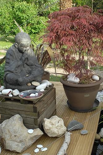 Biosphoto | 2073138 | Tibetan monk statue in meditation at the edge of a Zen garden pond, Jardin de l’Écriture et de la Poésie, Garden of Writing and Poetry, Eure et Loir, France | &copy; Catherine Fruhinsholz / Biosphoto