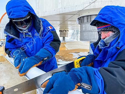 Biosphoto | 2595511 | Two scientists perform a series of measurements on a piece of snow to determine its structure, hardness, etc. near the feet of the Concordia station. Concordia Antarctic Research Station, Dome C plateau, East Antarctica. | &copy; Armand Patoir / Biosphoto