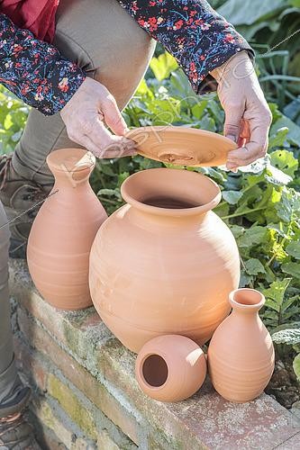 Biosphoto | 2572731 | Woman holding various models of oyas, or watering jars, to be buried at the foot of crops. | &copy; Jean-Michel Groult / Biosphoto