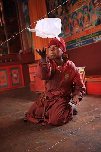 Biosphoto | 1075801 | Young Buddhist monk playing with a packet Muktinath Nepal | &copy; Antoine Boureau / Biosphoto