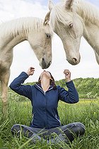 Biosphoto | 2578926 | Young girl and white horses in a meadow, France | &copy; Claudius Thiriet / Biosphoto